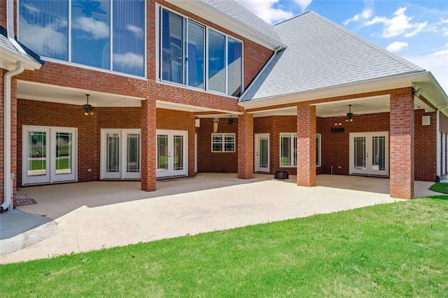 3030 Berry Rd, Loganville, GA 30052 - back of house featuring french doors, a ceiling fan, brick siding, and a lawn