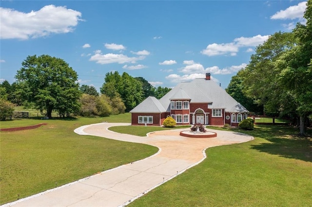3030 Berry Rd, Loganville, GA 30052 - back of property featuring a lawn, a chimney, brick siding, and curved driveway