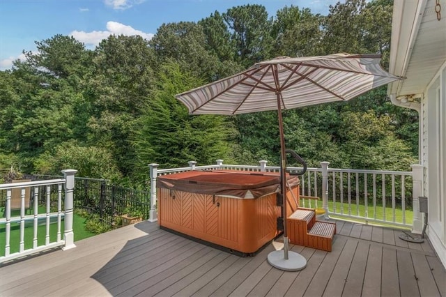 wooden deck featuring a hot tub