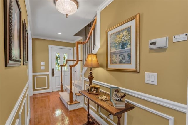 hallway featuring light hardwood / wood-style flooring and ornamental molding