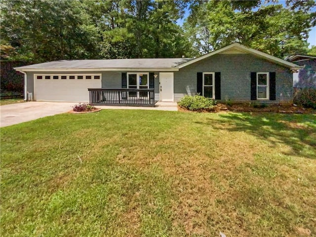 single story home with a garage, a front yard, brick siding, and driveway