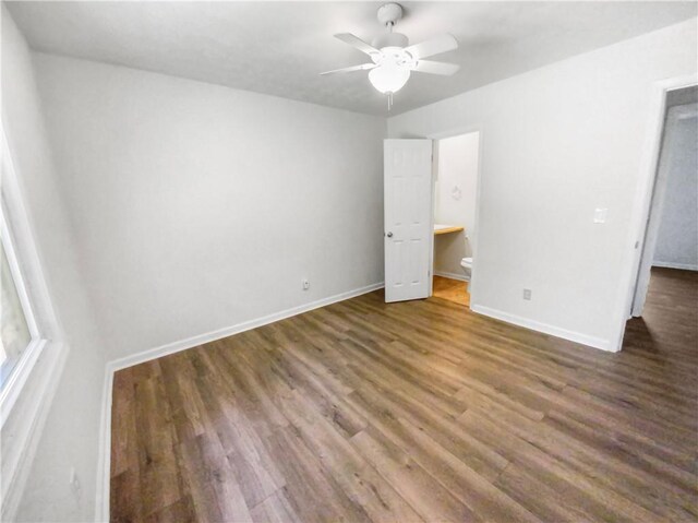 unfurnished bedroom with a ceiling fan, baseboards, and wood finished floors