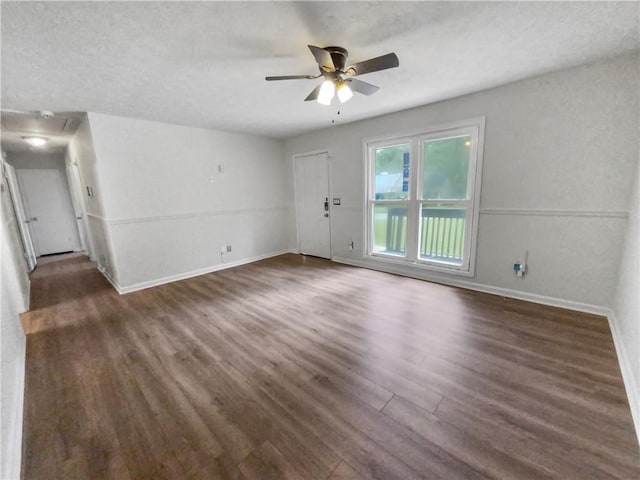 unfurnished living room featuring a ceiling fan, a textured ceiling, baseboards, and wood finished floors