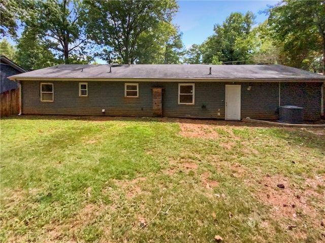 back of house with a yard and central AC unit