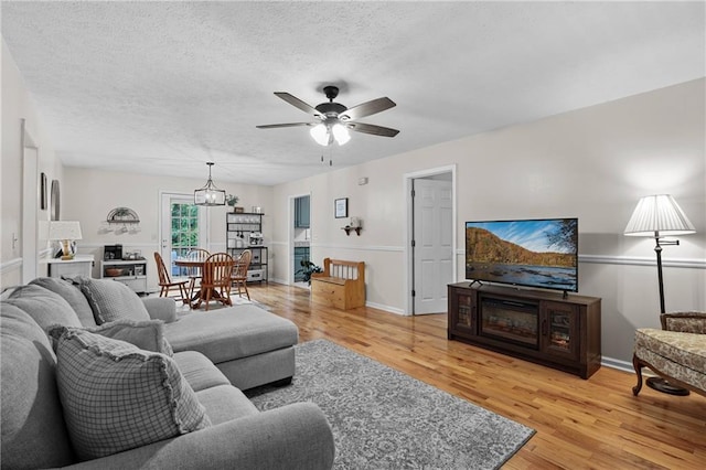 250 Vermont St, Demorest, GA 30535 - living room featuring a ceiling fan, light wood finished floors, a textured ceiling, and baseboards