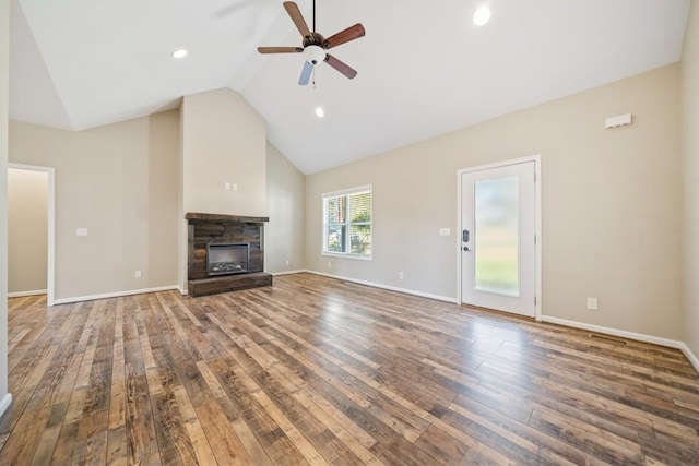 unfurnished living room with a stone fireplace, hardwood / wood-style floors, vaulted ceiling, and ceiling fan