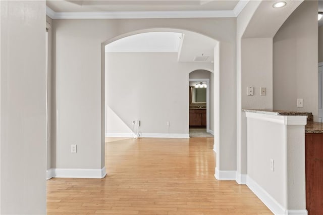 corridor featuring light hardwood / wood-style floors and crown molding