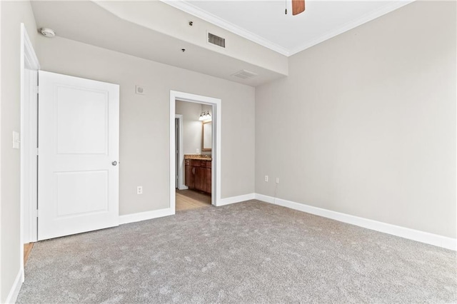 unfurnished bedroom with connected bathroom, crown molding, light colored carpet, and ceiling fan