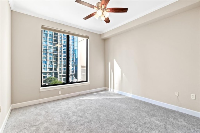 empty room with a wealth of natural light, crown molding, and light carpet