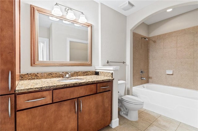 full bathroom with vanity, toilet, tiled shower / bath combo, and tile patterned flooring