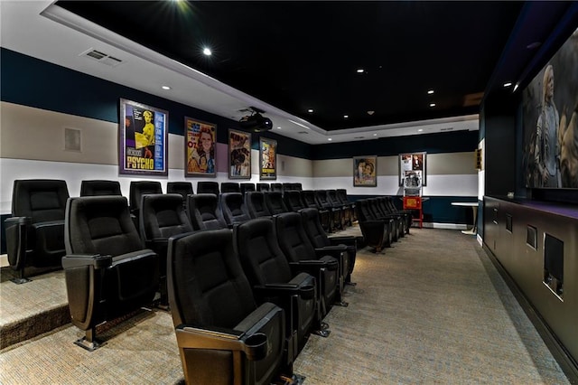 carpeted home theater with a raised ceiling