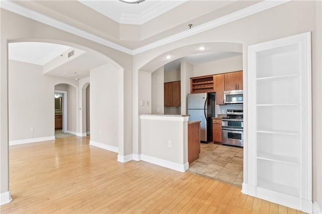 kitchen featuring appliances with stainless steel finishes, crown molding, and light hardwood / wood-style floors