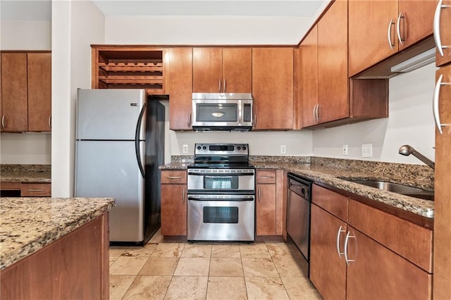 kitchen with sink, appliances with stainless steel finishes, and stone countertops