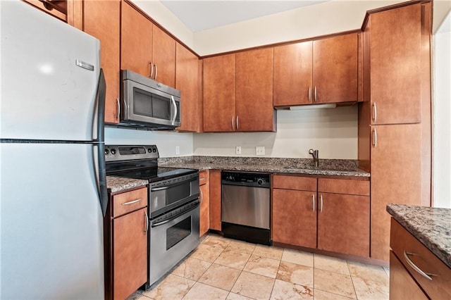 kitchen featuring sink, appliances with stainless steel finishes, and dark stone counters