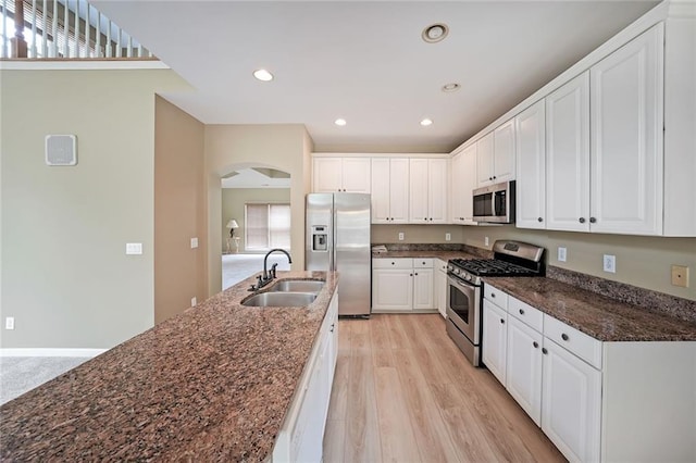 2747 Harper Woods Dr, Marietta, GA 30062 - kitchen with appliances with stainless steel finishes, a sink, white cabinets, light wood-style floors, and recessed lighting