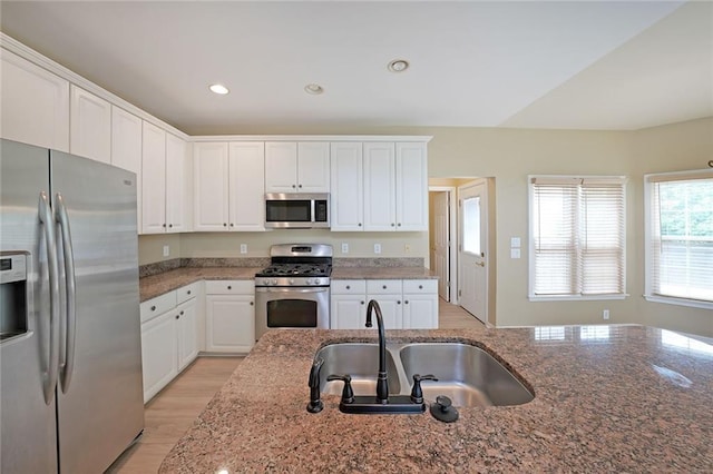 2747 Harper Woods Dr, Marietta, GA 30062 - kitchen featuring stainless steel appliances, a sink, white cabinetry, dark stone counters, and recessed lighting