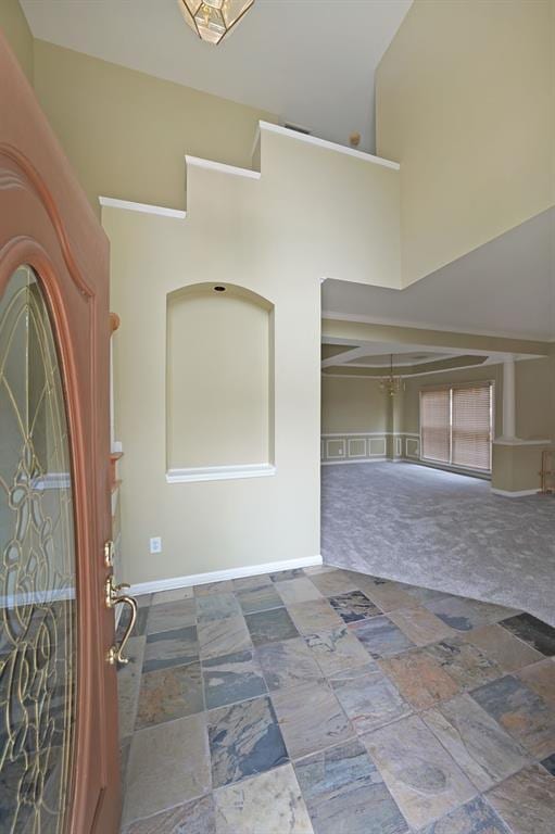 2747 Harper Woods Dr, Marietta, GA 30062 - entrance foyer featuring high vaulted ceiling, baseboards, carpet flooring, and stone finish flooring