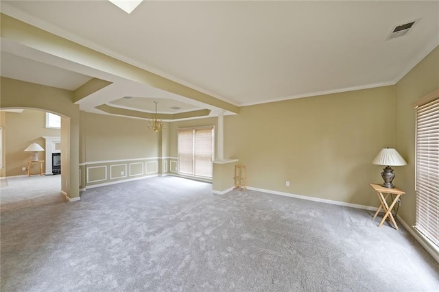 2747 Harper Woods Dr, Marietta, GA 30062 - empty room featuring carpet floors, arched walkways, a fireplace, a chandelier, and ornamental molding