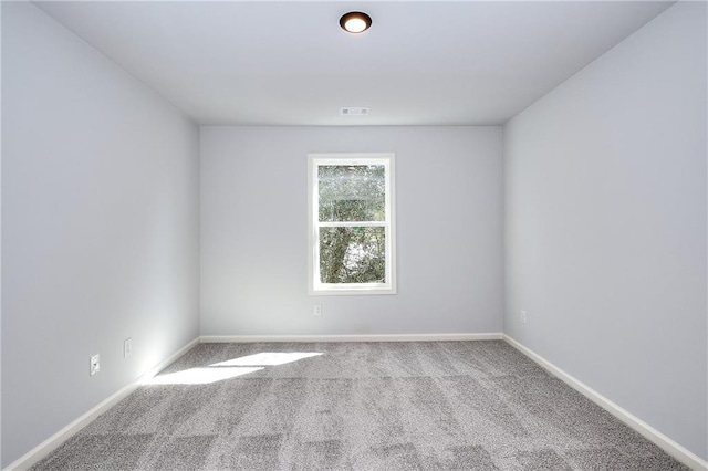 unfurnished room with light colored carpet