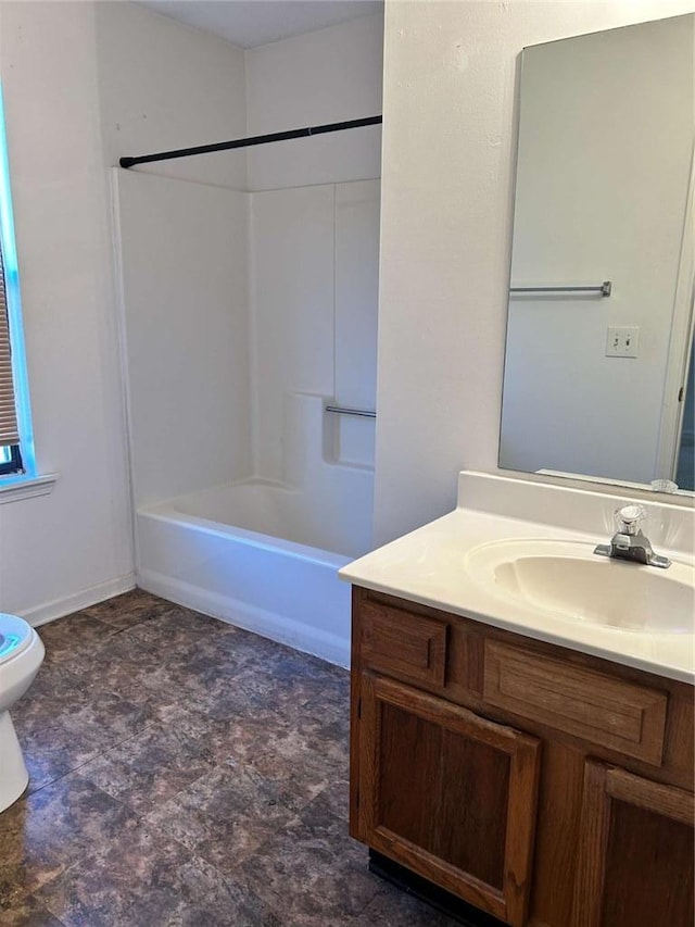 bathroom with tub / shower combination, vanity, toilet, and baseboards