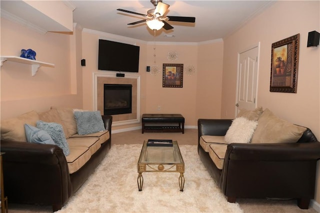 living room featuring carpet floors, crown molding, a fireplace, and ceiling fan