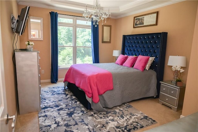 carpeted bedroom with ornamental molding, a chandelier, and a tray ceiling