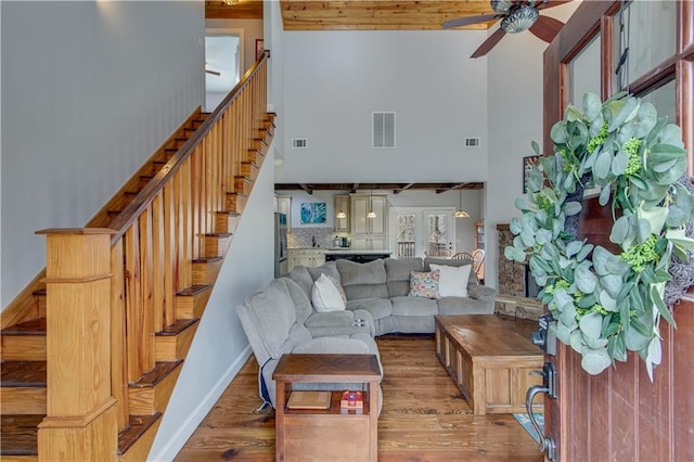 living room featuring ceiling fan, high vaulted ceiling, and light hardwood / wood-style flooring