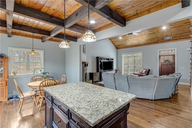 kitchen with pendant lighting, wood ceiling, dark brown cabinets, light hardwood / wood-style floors, and a kitchen island