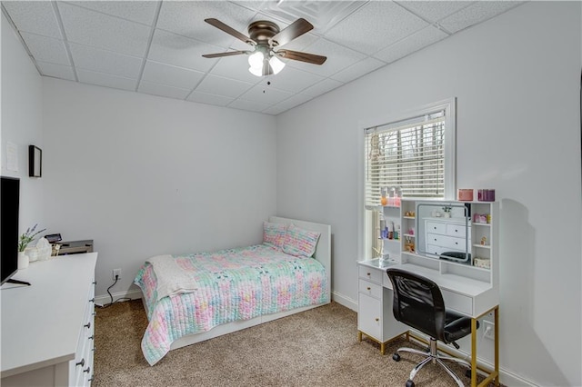 carpeted bedroom with a drop ceiling and ceiling fan