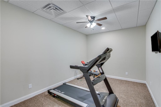 exercise room featuring ceiling fan, carpet flooring, and a drop ceiling