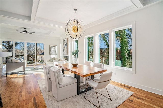 dining area featuring beam ceiling, ceiling fan with notable chandelier, and light hardwood / wood-style flooring