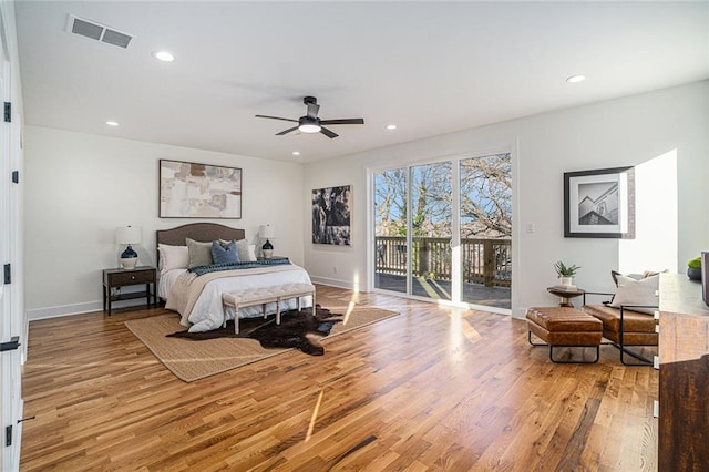 bedroom featuring ceiling fan, light hardwood / wood-style flooring, and access to outside