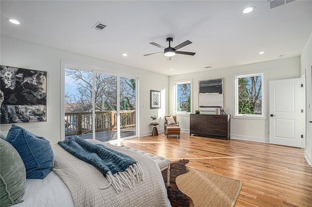 bedroom featuring light hardwood / wood-style floors, ceiling fan, and access to outside