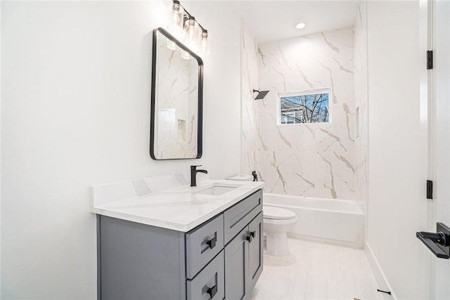 full bathroom with tiled shower / bath combo, vanity, and toilet