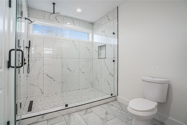 bathroom featuring toilet and a shower with shower door