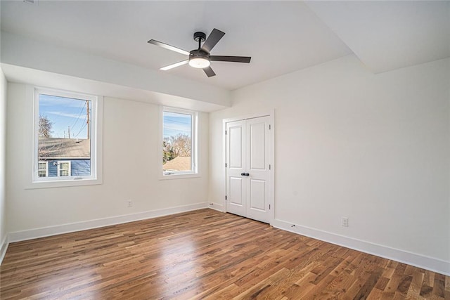 spare room with hardwood / wood-style flooring and ceiling fan