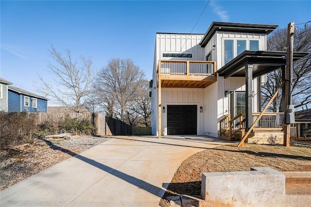 view of front of home featuring a balcony and a garage