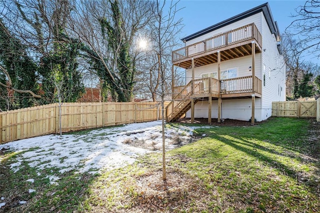 back of house featuring a wooden deck and a yard