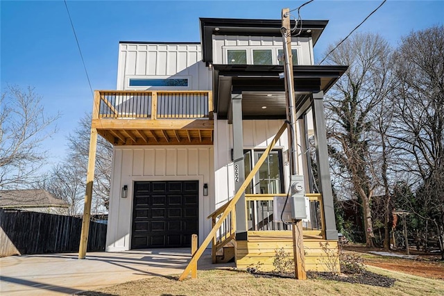 view of front facade featuring a garage and a balcony