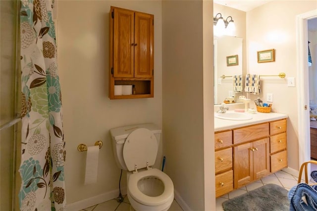 bathroom featuring toilet, vanity, and tile patterned floors