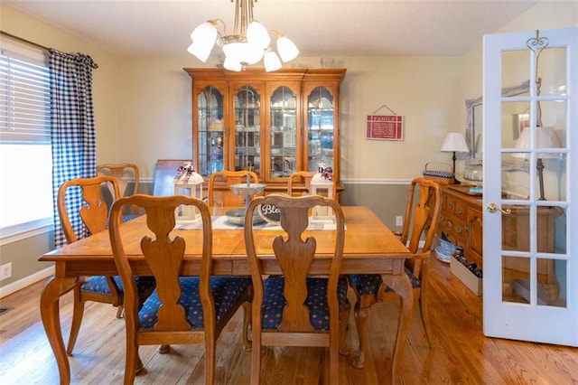 dining area featuring a chandelier and light hardwood / wood-style floors