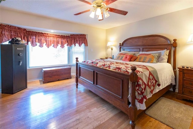 bedroom with light hardwood / wood-style floors and ceiling fan