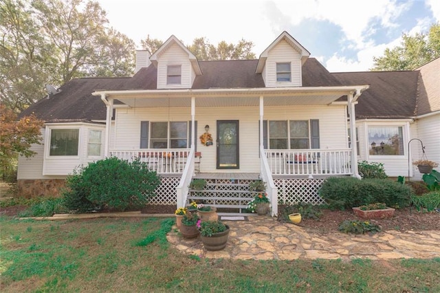 cape cod house featuring covered porch