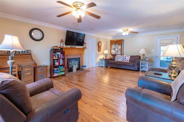 living room with light hardwood / wood-style floors, ceiling fan, and crown molding