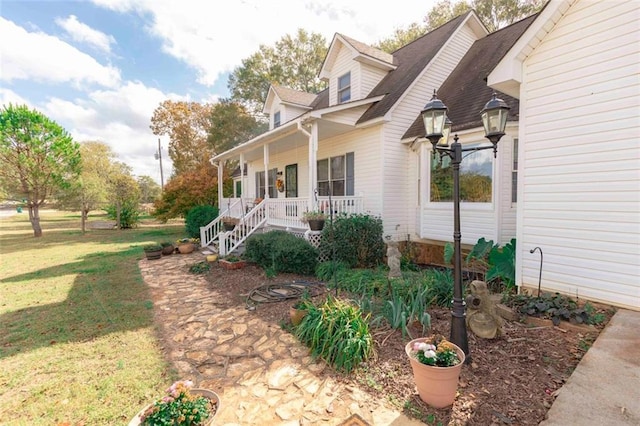 view of property exterior with a lawn and covered porch