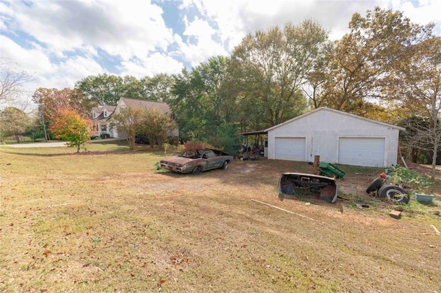 view of yard with a garage and an outdoor structure