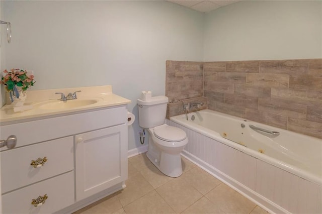 bathroom with tile patterned flooring, vanity, toilet, and a relaxing tiled tub