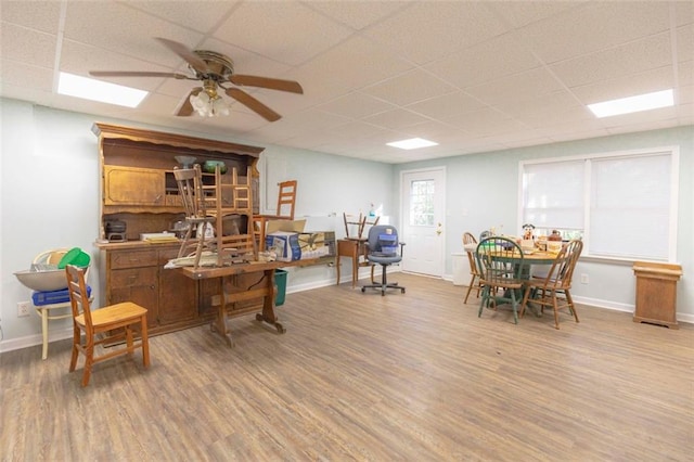 office with ceiling fan, wood-type flooring, and a drop ceiling