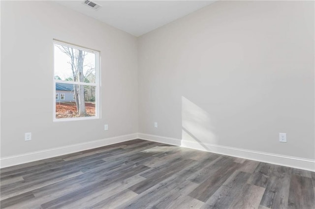 spare room featuring dark hardwood / wood-style flooring