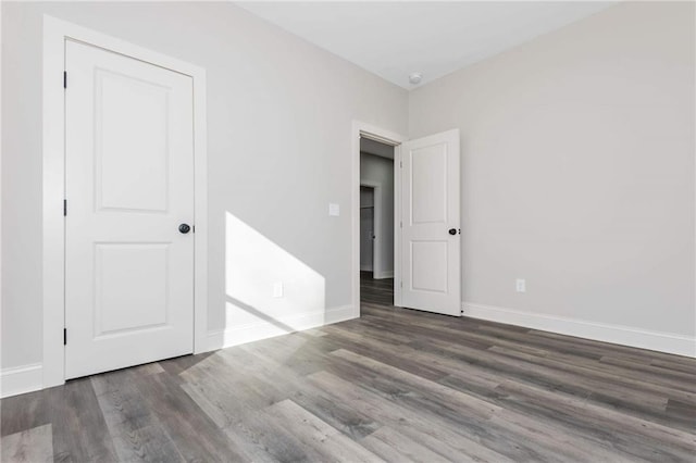 spare room with dark hardwood / wood-style flooring